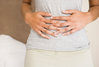 getty_rf_photo_of_woman_holding_abdomen.jpg