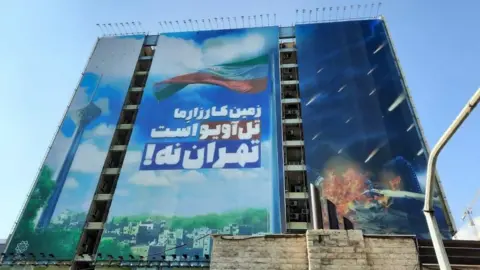 Supplied Tel Aviv is our battleground not Tehran, says a propaganda billboard in the Iranian capital