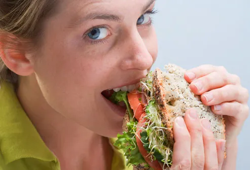 getty_rf_photo_of_woman_eating_sandwich.jpg