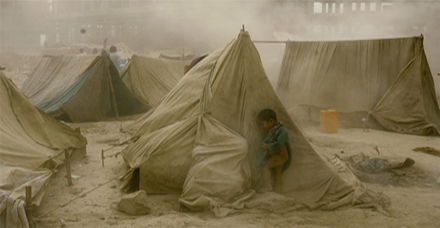 An_Afghan_refugee_child_hides_from_a_dust_storm.jpg