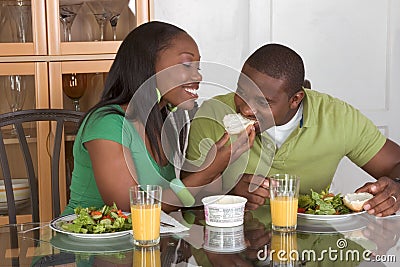 young-ethnic-couple-by-table-eating-breakfast-thumb10718814.jpg