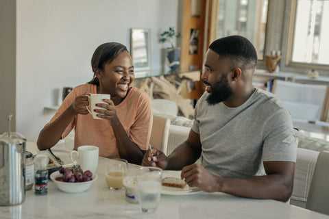 couple at home talking about their day over coffee