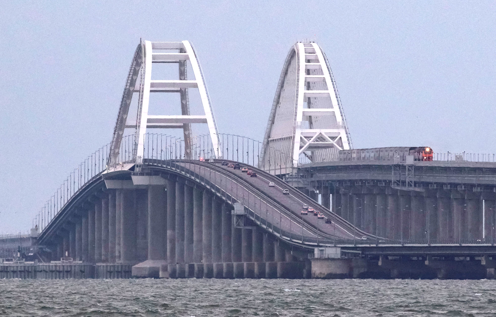 A passenger train and cars travel on the Kerch bridge in Crimea, on October 9. 