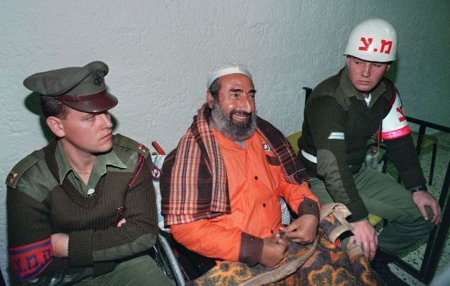 Ahmed Yassin sittingh next to Israeli guards