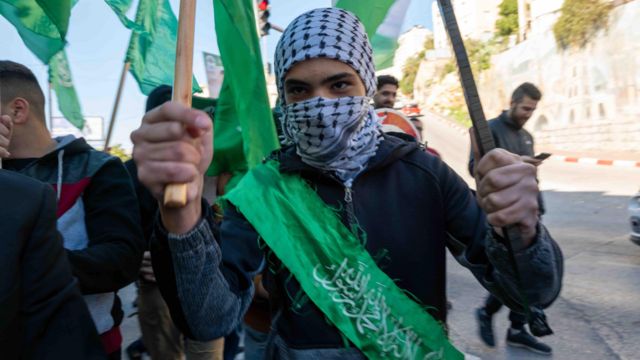 Hamas supporters march through the streets of Nablus in the occupied West Bank on 15 December 2023