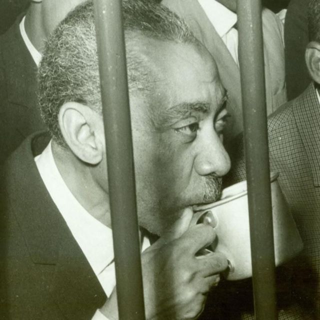Sayyid Qutb behind bars, sipping from a cup