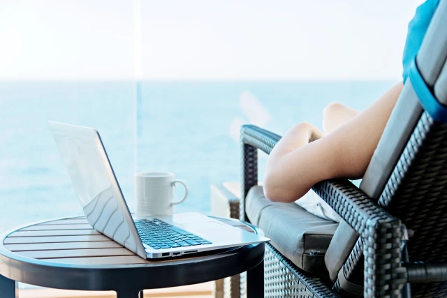 Woman relaxing on a cruise ship next to her laptop