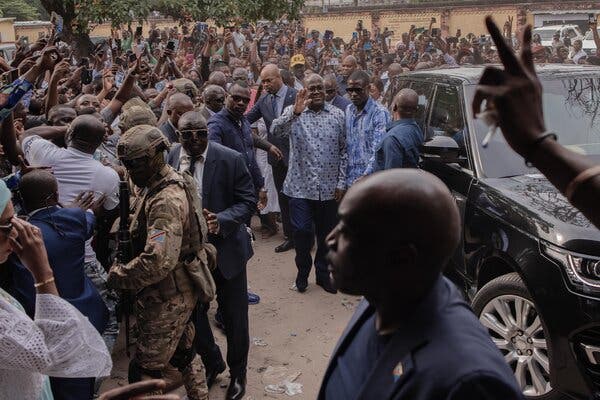 Mr. Tshisekedi waving to a large crowd.