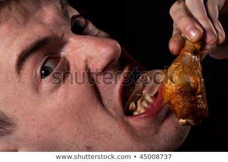 hungy-man-eating-chicken-450w-45008737.jpeg