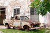 9062305-very-old-car-wreck-rusty-and-scrapped-in-front-of-old-house.jpg