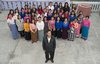 Ziona Chana poses with his 39 wives.jpg