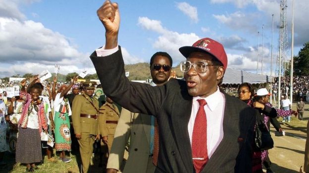Robert Mugabe greets Zanu PF followers on his arrival for a rally in the city of Mutare some 290 km east of the capital Harare, 09 June 2000