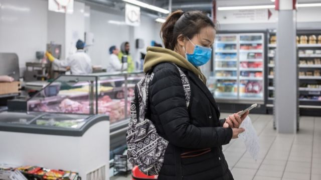 Woman wearing a facemask in a London supermarket