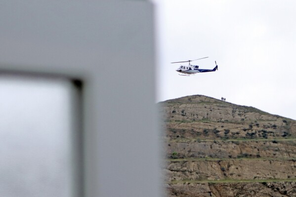 In this photo provided by Islamic Republic News Agency, IRNA, the helicopter carrying Iranian President Ebrahim Raisi takes off at the Iranian border with Azerbaijan after President Raisi and his Azeri counterpart Ilham Aliyev inaugurated the dam of Qiz Qalasi, or Castel of Girl in Azeri, Iran, Sunday, May 19, 2024. A helicopter carrying President Raisi suffered a hard landing on Sunday, Iranian state media reported, without elaborating. (Ali Hamed Haghdoust/IRNA via AP)