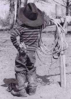Young boy dressed in western wear with a lasso, symbolizing a green hat hacker.