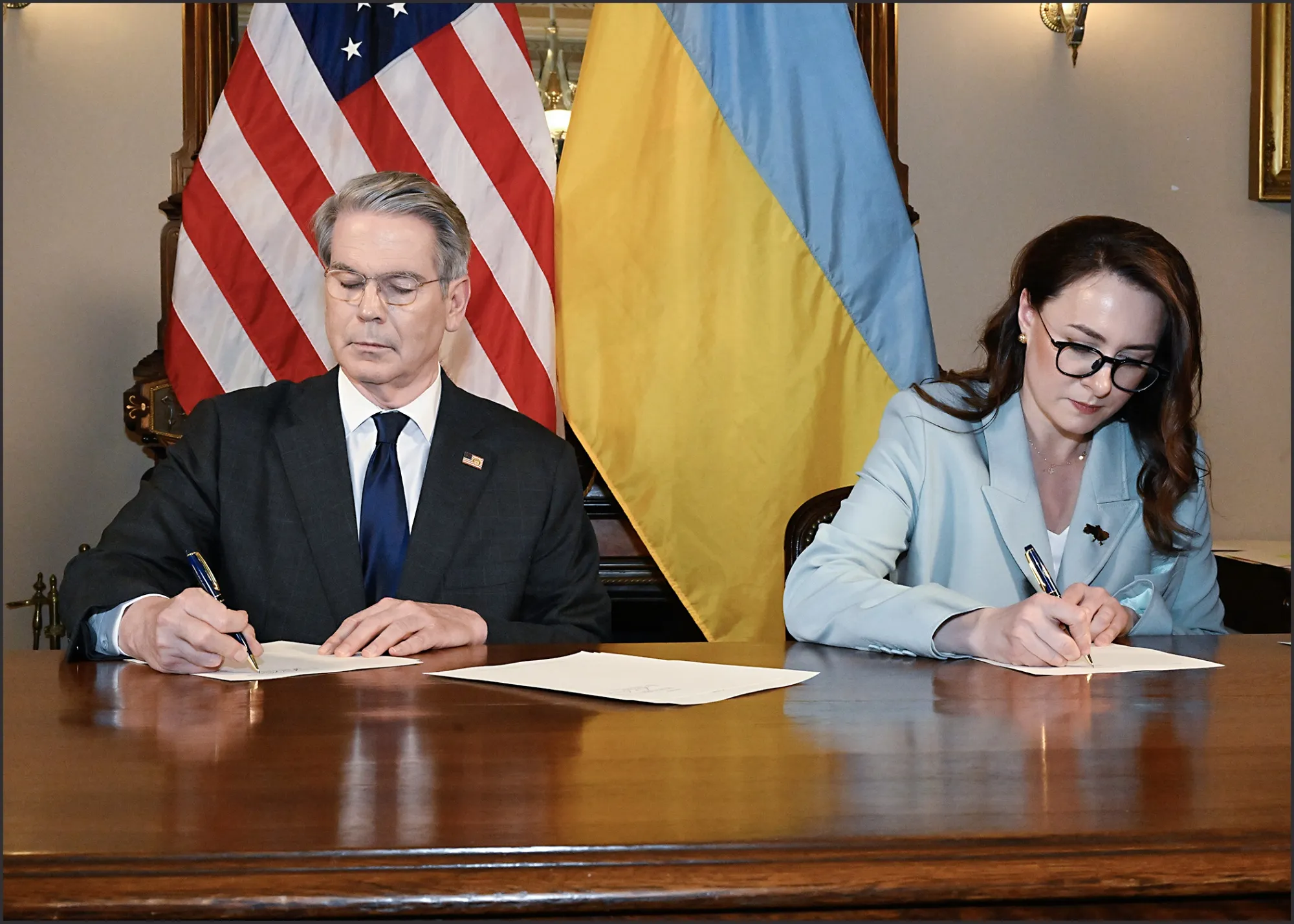 Scott Bessent and Yulia Svyrydenko sign the deal granting the US privileged access to develop Ukraine’s natural resources.