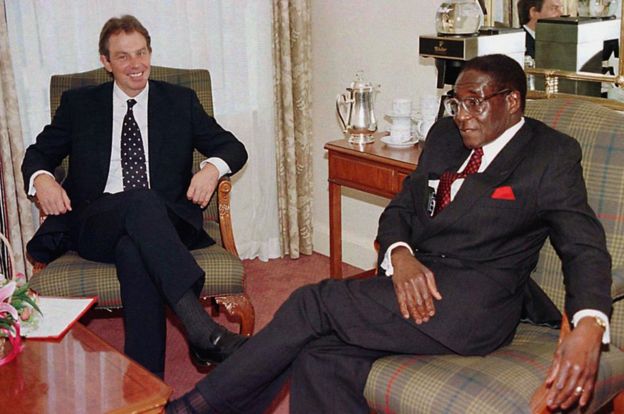 Tony Blair chats with President Robert Mugabe of Zimbabwe 24 October 1997 in Edinburgh, before the start of the Commonwealth Heads of Government meeting.