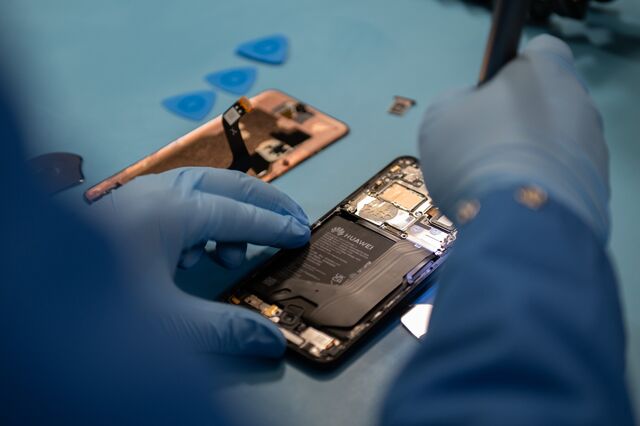 A specialist disassembles a Huawei Technologies Co. Mate 60 Pro smartphone