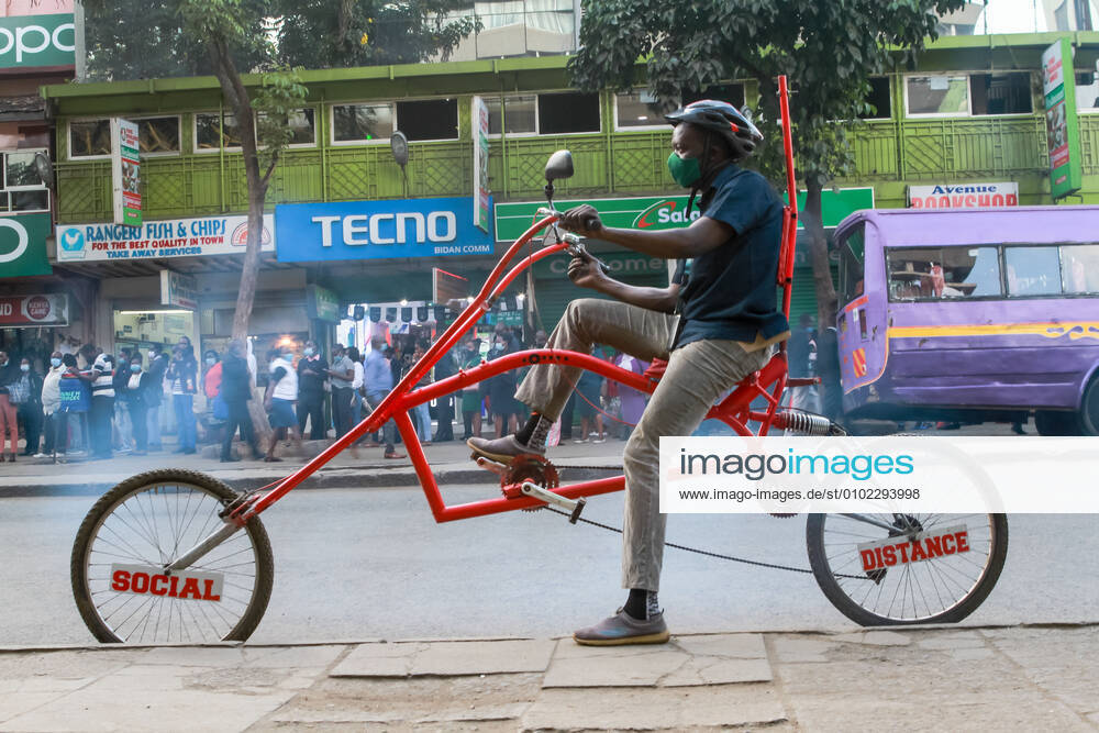 July 9, 2020, Nairobi, Kenya A man rides along Ronald Ngala Street on his  creative homemade bike raising