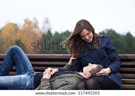 stock-photo-man-lying-in-lap-of-young-woman-on-park-bench-117445393.jpg