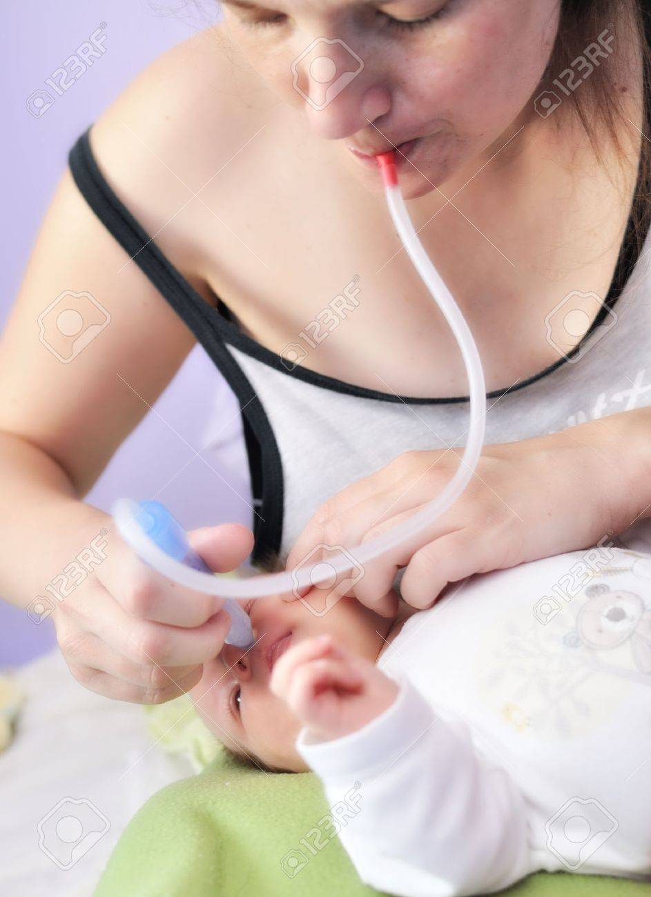 25086714-Mother-suction-catarrh-from-the-nose-her-baby-Stock-Photo-baby.jpg