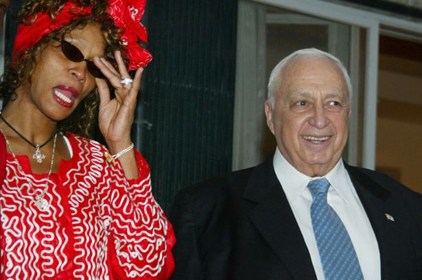 Israeli+Prime+Minister+Ariel+Sharon+smiles+as+he+meets+with+American+singer+Whitney+Houston+in+Jerusalem+May+27%2C+2003