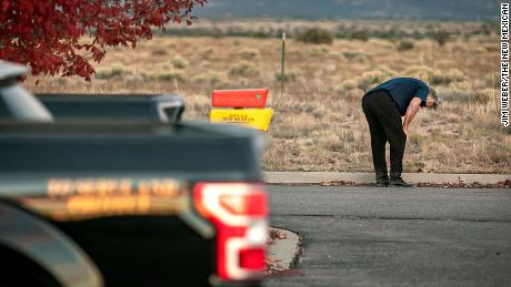 A distraught Alec Baldwin lingers in the parking lot outside the Santa Fe County sheriff's offices after being questioned Thursday about a shooting on a local movie set.