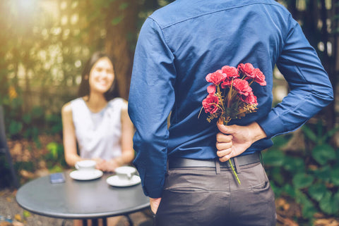 husband surprising wife with flowers