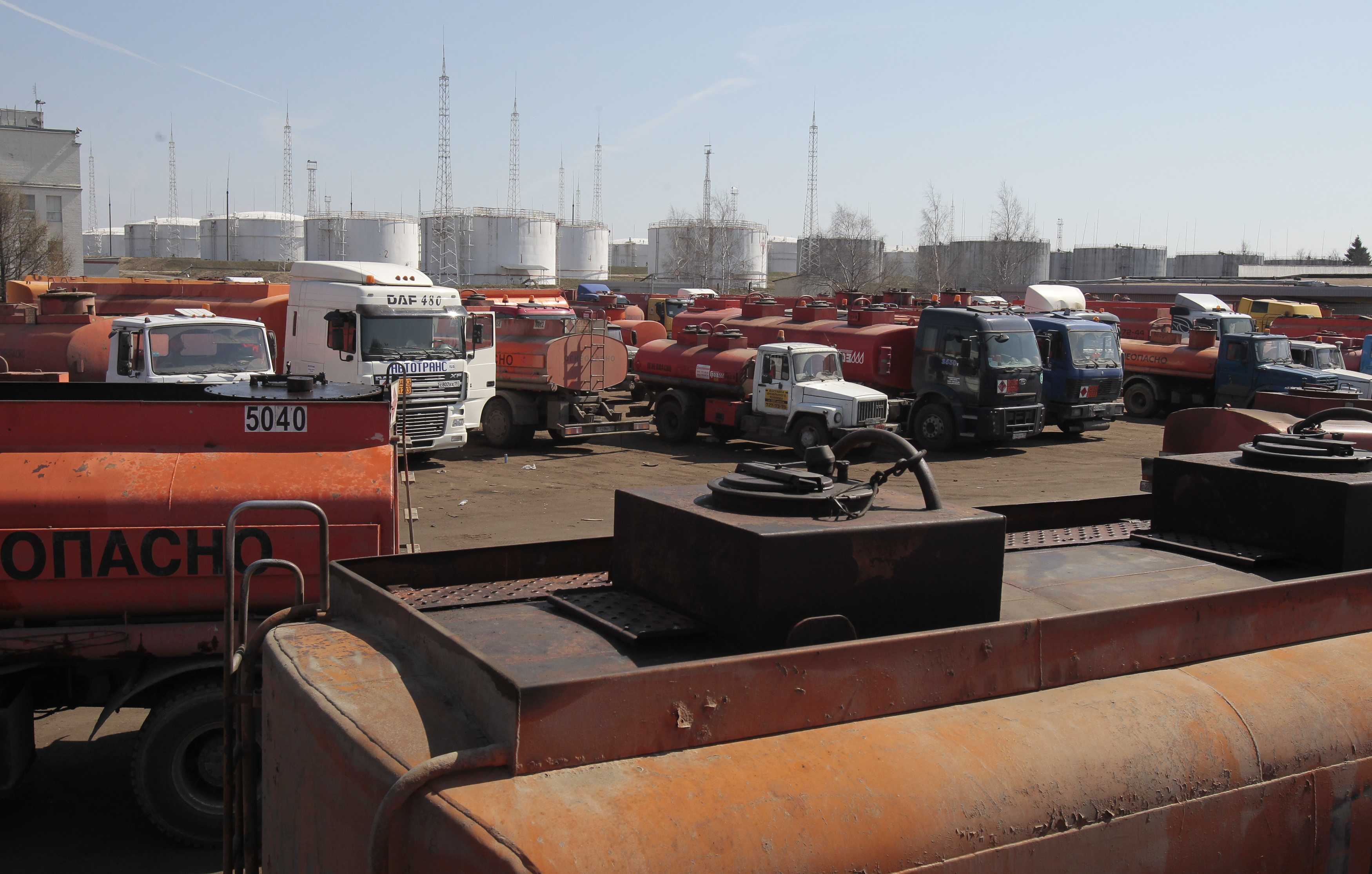 Empty petrol tankers wait to fill up at a tanker filling station some 30kms outside Moscow