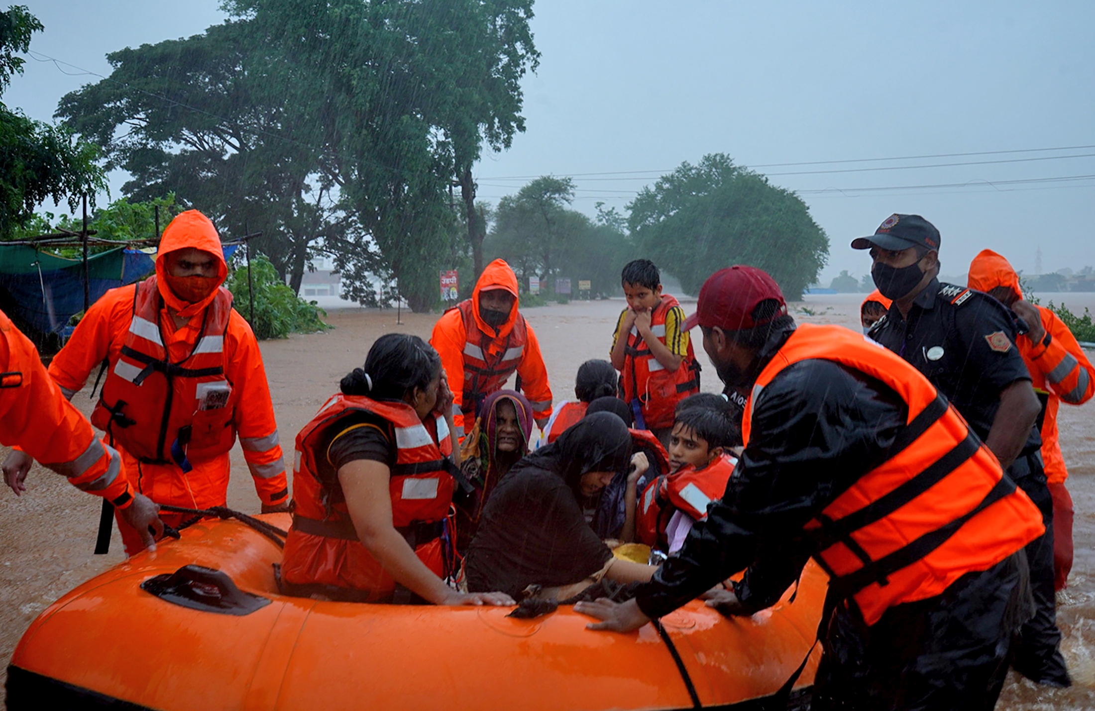 Rescue workers evacuate people from a flooded area to safer places after heavy rains in Kolhapur in the western state of Maharashtra, India, July 23, 2021. REUTERS/Abhijeet Gurjar