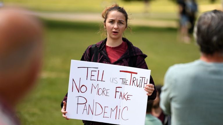 A woman holds a placard at an anti-coronavirus lockdown demonstration in Hyde Park in London on May 16, 2020, following an easing of lockdown rules in England during the novel coronavirus COVID-19 pandemic. - Fliers advertising 'mass gatherings' organised by the UK Freedom Movement to oppose the government lockdown measures and guidelines put in place to halt the spread of coronavirus in parks around the UK calling for attendees to bring a picnic and music have been circulating on social media. 'mass gatherings' organised by the UK Freedom Movement to oppose the government lockdown measures and guidelines put in place to halt the spread of coronavirus in parks around the UK calling for attendees to bring a picnic and music have been circulating on social media. 