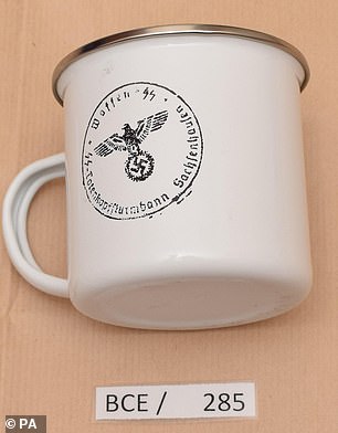 5057182-6277601-A_mug_displaying_the_emblem_of_the_Nazi_era_SS_organisation_foun-m-217_1539619479096.jpg