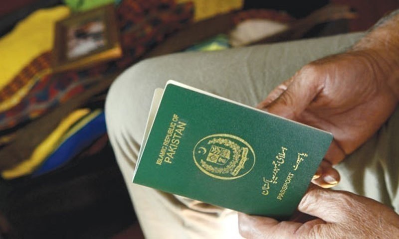 A man holding a Pakistani passport.