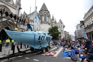 Protesters from Extinction Rebellion with a boat that they have parked outside the Royal Courts of Justice in London.