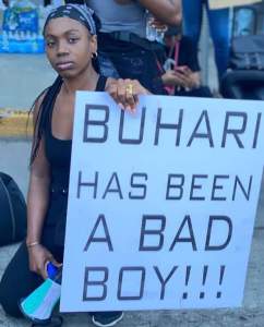 lady holds Buhari has been a bad boy'' banner