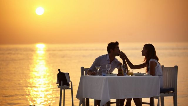 A couple enjoying a romantic dinner on the beach