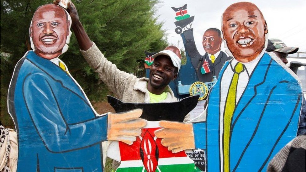 vendor holds an artistic expression representing Kenyas President-elect William Ruto and his deputy Rigathi Gachagua outside his official residence in Karen district of Nairobi, Kenya, August 17, 2022.