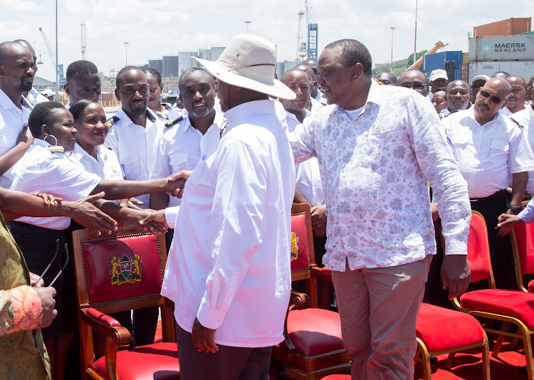 President Uhuru Kenyatta and Ugandan President Yoweri Museveni greet Kenya Ports Authority staff when they toured the Port of Mombasa.