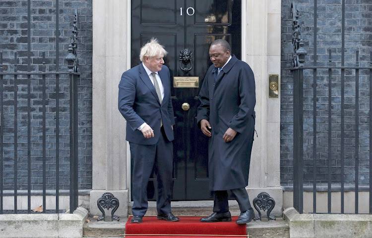 President Uhuru Kenyatta chats with UK Prime Minister Boris Johnson after a joint press conference in London