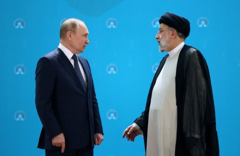 Iranian President Ebrahim Raisi and Russian President Vladimir Putin speak to each other before a trilateral meeting on Syria with Turkish President in Tehran on July 19, 2022. (Photo by Sergei Savostyanov / SPUTNIK / AFP) (Photo by SERGEI SAVOSTYANOV/SPUTNIK/AFP via Getty Images)