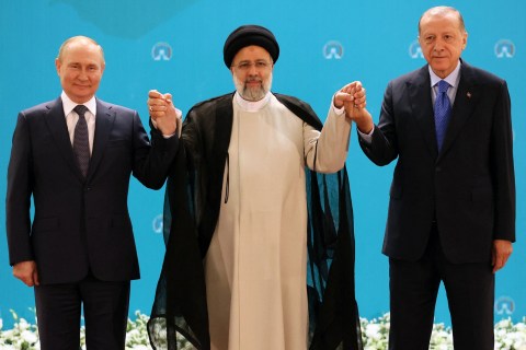 TOPSHOT - (L-R) Russian President Vladimir Putin, Iranian President Ebrahim Raisi and Turkish President Recep Tayyip Erdogan pose for a photo before a trilateral meeting on Syria in Tehran on July 19, 2022. (Photo by Sergei Savostyanov / SPUTNIK / AFP) (Photo by SERGEI SAVOSTYANOV/SPUTNIK/AFP via Getty Images)