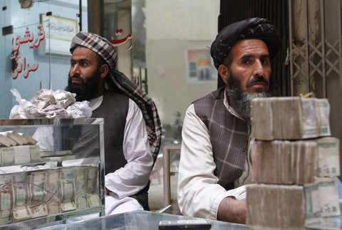 Afghan dealers wait for customers at a money market in Kandahar province.