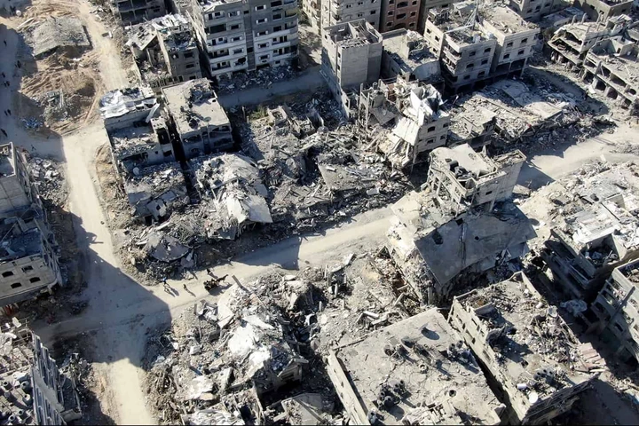 An aerial view on December 26, 2023 shows destroyed buildings in Beit Lahia following Israeli bombardments in the northern Gaza Strip, amid ongoing battles between Israel and the Palestinian militant group Hamas. (Photo by AFP)
