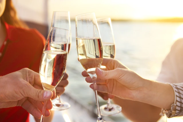 Friends toasting champagne on a cruise
