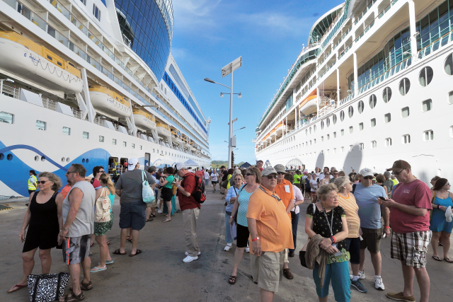 Crowd of people boarding a cruise ship