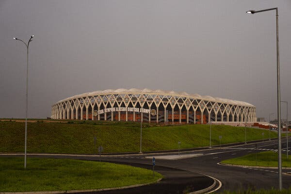 A stadium surrounded by empty roads. 