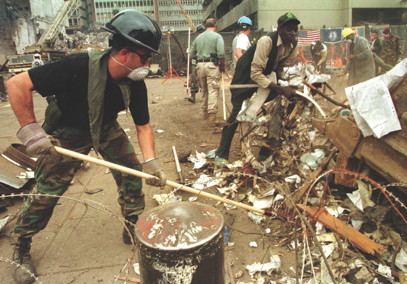 An FBI agent rakes through debris looking for clues following the car bombing of the U.S. Embassy in Kenya in August 1998. Reuters.