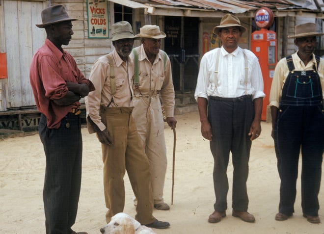 In this 1950's photo released by the National Archives, men included in a syphilis study pose for a photo in Tuskegee, Ala. For 40 years starting in 1932, medical workers in the segregated South withheld treatment for unsuspecting men infected with a sexually transmitted disease simply so doctors could track the ravages of the horrid illness and dissect their bodies afterward. It was finally exposed in 1972. 