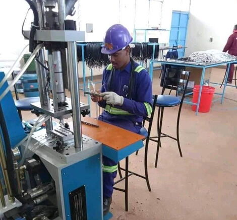 An employee at the USB manufacturing station desk