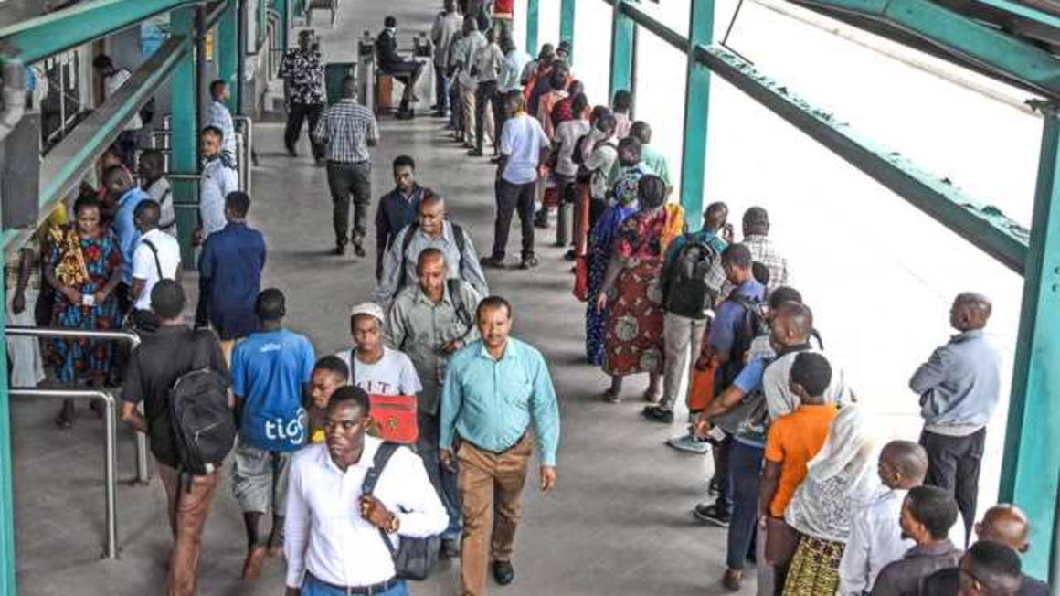 People queue at the Kimara Bus Station in Dar es Salaam. 